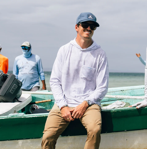 A man wearing Fish Hippie solmar performance hoodie