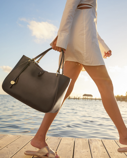 A woman carrying Dooney and Bourke alto camilla handbag