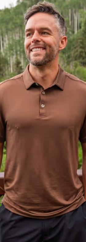 A man wearing BURLEBO performance polo - heather brown