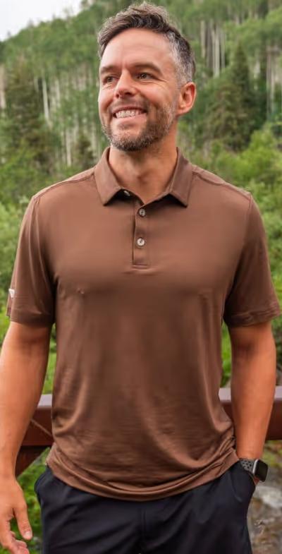 A man wearing BURLEBO performance polo - heather brown