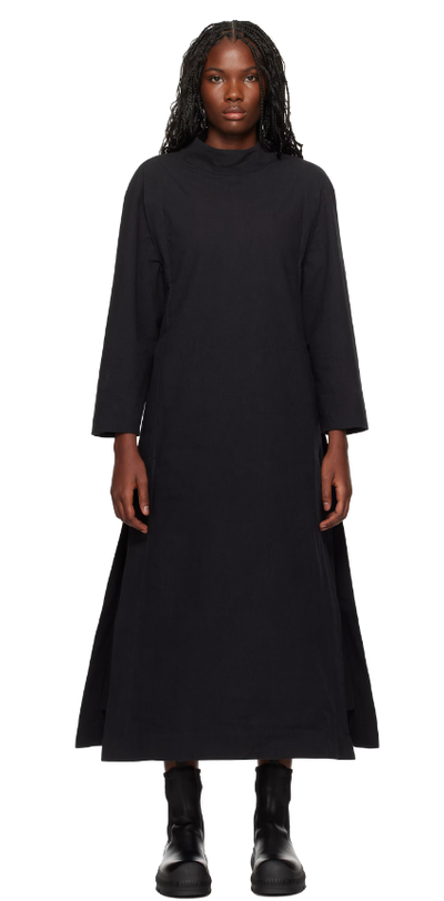 A woman wearing Toogood black 'the scuba diver' midi dress