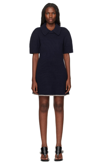 A woman wearing The Garment navy canada minidress