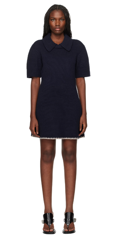 A woman wearing The Garment navy canada minidress