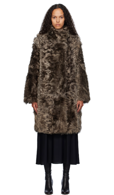 A woman wearing Yves Salomon brown toscana folk reversible shearling jacket