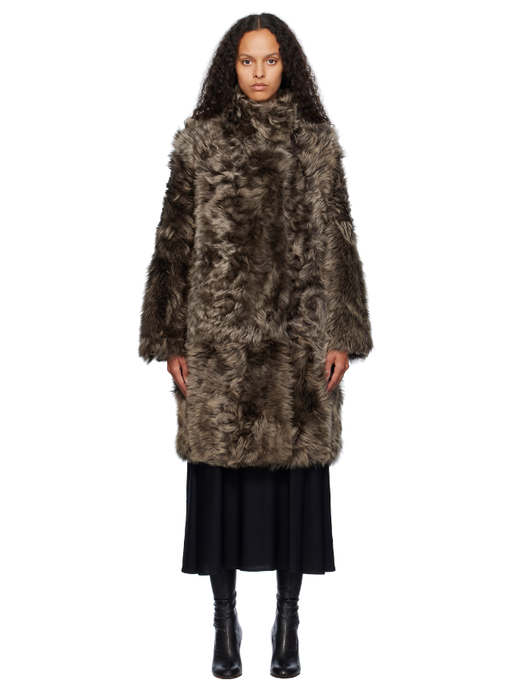 A woman wearing Yves Salomon brown toscana folk reversible shearling jacket