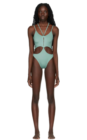 A woman wearing Rui ssense exclusive green one-piece swimsuit