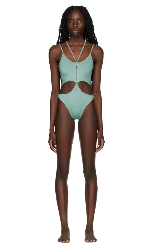 A woman wearing Rui ssense exclusive green one-piece swimsuit