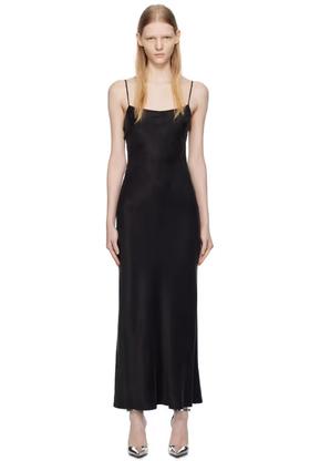 A woman wearing THIRD FORM black lip service bias maxi dress