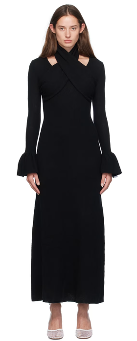 A woman wearing Rokh black cross knitted maxi dress