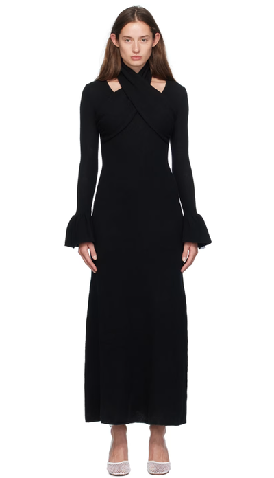 A woman wearing Rokh black cross knitted maxi dress