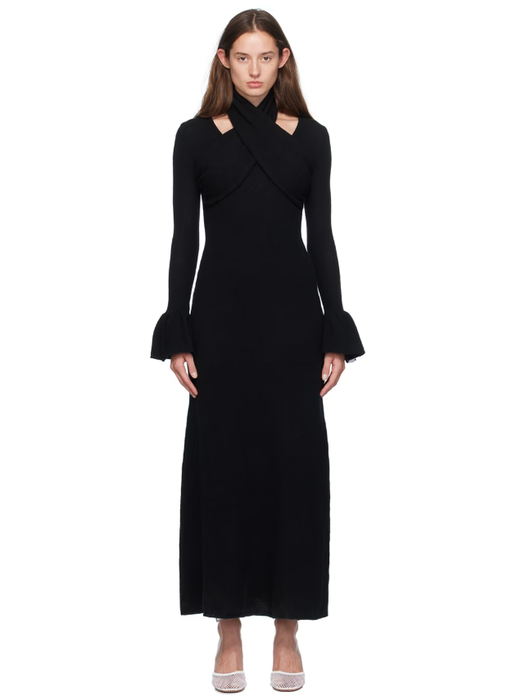 A woman wearing Rokh black cross knitted maxi dress