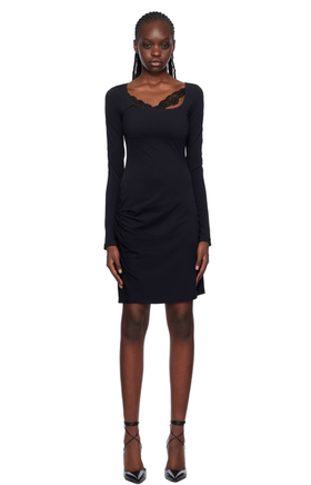 A woman wearing VAILLANT black draped midi dress