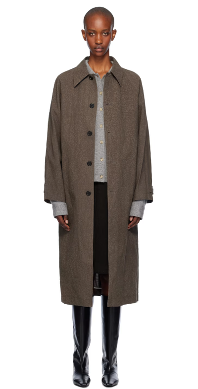 A woman wearing UMBER POSTPAST brown salt dyed cotton long coat