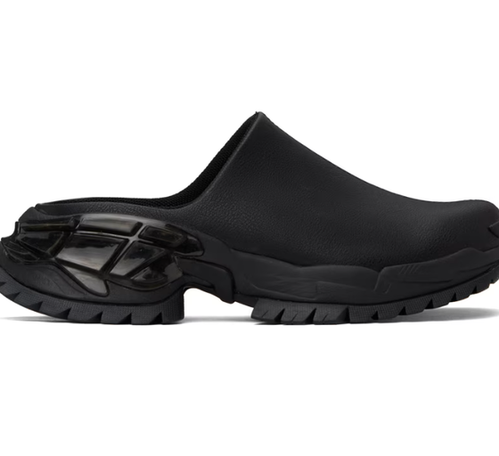 A woman wearing Rombaut black illusion mules