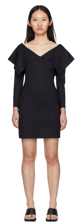 A woman wearing Rosetta Getty black fold off-shoulder dress