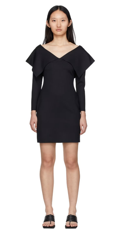 A woman wearing Rosetta Getty black fold off-shoulder dress