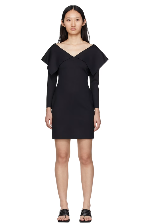 A woman wearing Rosetta Getty black fold off-shoulder dress