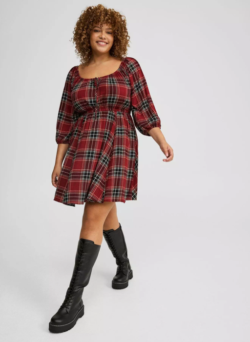 A woman wearing Torrid washable gauze babydoll mini dress