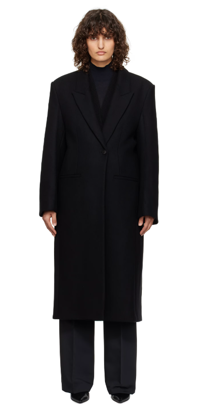 A woman wearing Róhe black opera coat