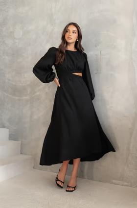 A woman wearing Petal & Pup ginnee puff sleeve cutout midi dress - black