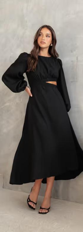 A woman wearing Petal & Pup ginnee puff sleeve cutout midi dress - black