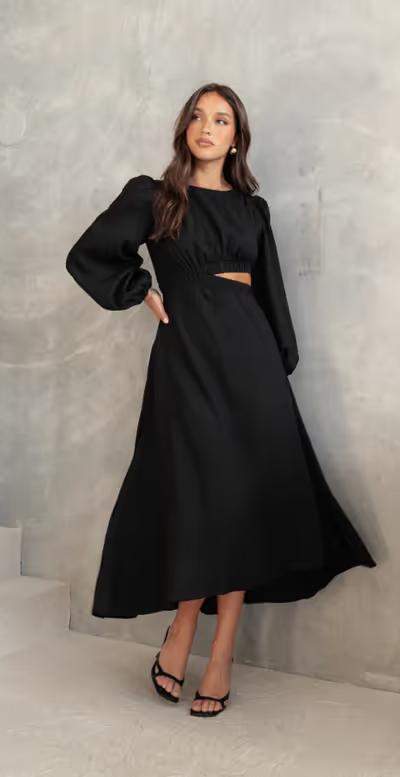 A woman wearing Petal & Pup ginnee puff sleeve cutout midi dress - black