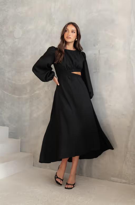 A woman wearing Petal & Pup ginnee puff sleeve cutout midi dress - black