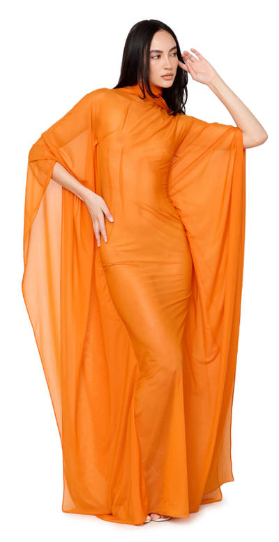 A woman wearing LaQuan Smith mockneck gown with sweeping dolman sleeves