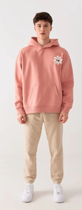 A man wearing Amoo​ fleur pink hoodie