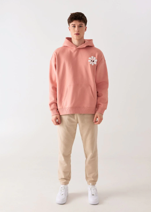 A man wearing Amoo fleur pink hoodie