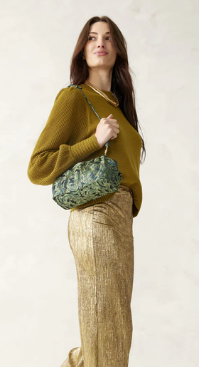 A woman carrying Vera Bradley​ wicked taber dumpling bag