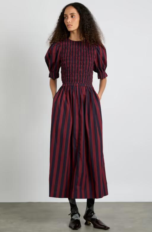 A woman wearing Damson Madder​ bluebelle midi dress - red/navy