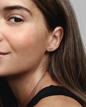 A woman wearing Pandora november honey eternity circle stud earrings