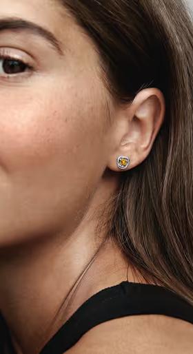 A woman wearing Pandora​ november honey eternity circle stud earrings