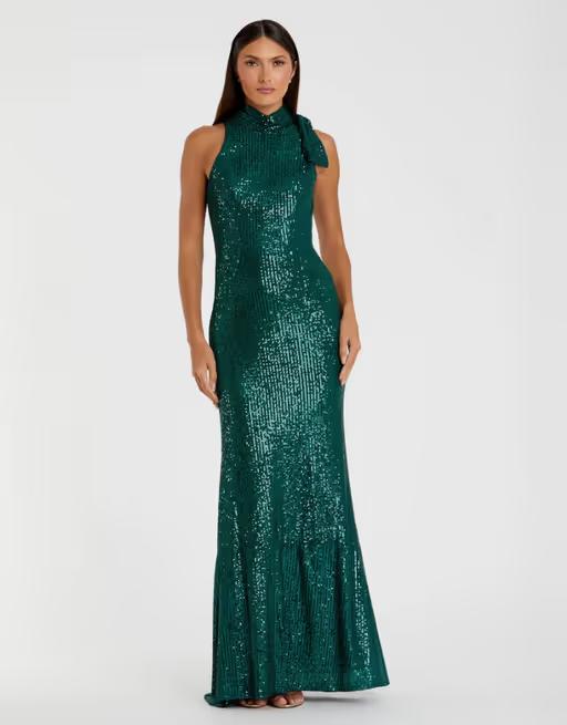 A woman wearing Mac Duggal​ sequined soft tie halter neck column gown