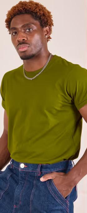A man wearing Big Bud Press​ the organic vintage tee - summer olive