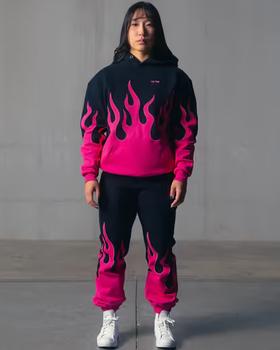 A woman wearing Kill Crew oversized premium heater hoodie - black / pink