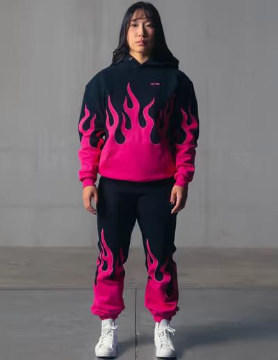 A woman wearing Kill Crew oversized premium heater hoodie - black / pink