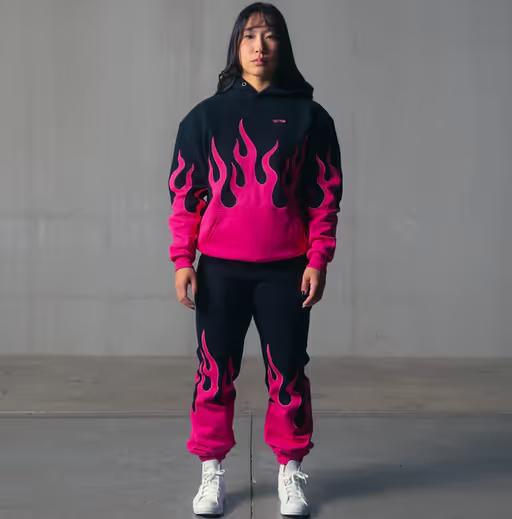 A woman wearing Kill Crew oversized premium heater hoodie - black / pink