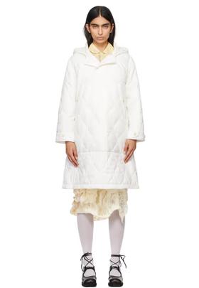 A woman wearing Tao Comme Des Garçons white taffeta quilting coat