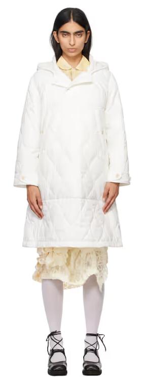 A woman wearing Tao Comme Des Garçons white taffeta quilting coat