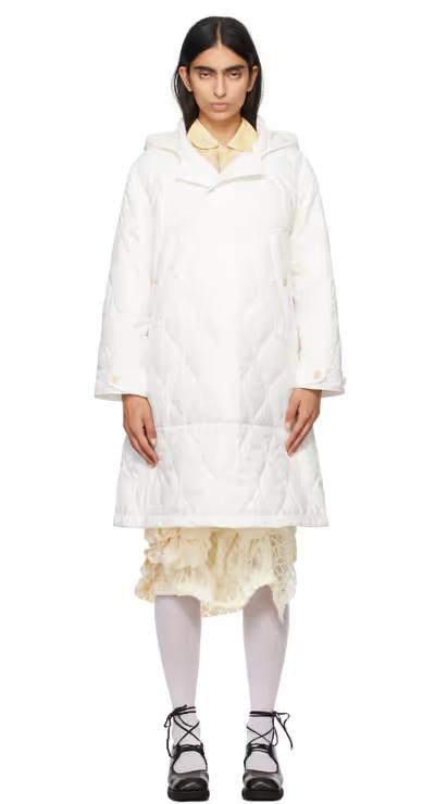 A woman wearing Tao Comme Des Garçons white taffeta quilting coat