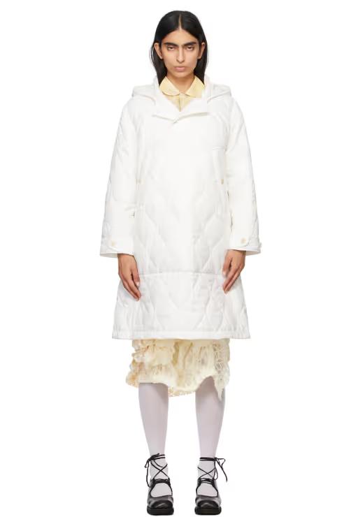 A woman wearing Tao Comme Des Garçons white taffeta quilting coat