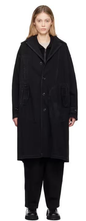 A woman wearing Y's black faded denim coat