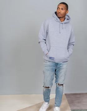 A man wearing SERHANT. heather grey hoodie