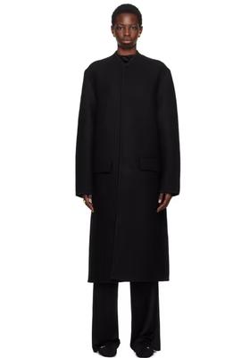 A woman wearing Rier black walker coat