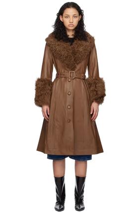 A woman wearing Saks Potts brown foxy shearling coat