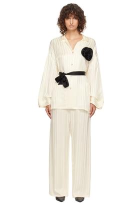 A woman wearing Sleeper off-white rose oversized satin pyjama set