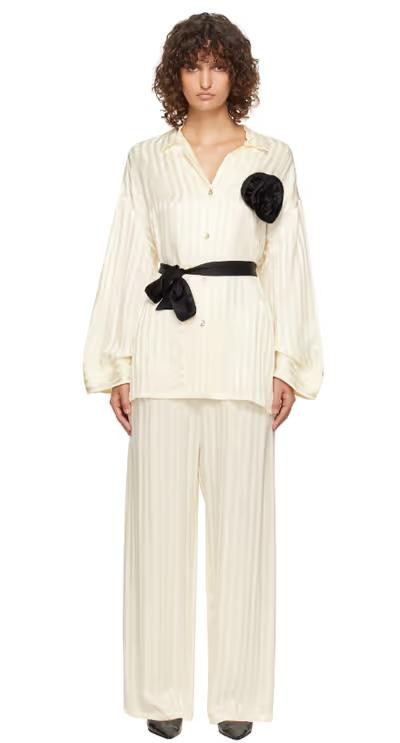 A woman wearing Sleeper off-white rose oversized satin pyjama set