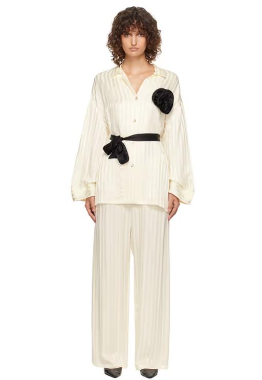 A woman wearing Sleeper off-white rose oversized satin pyjama set